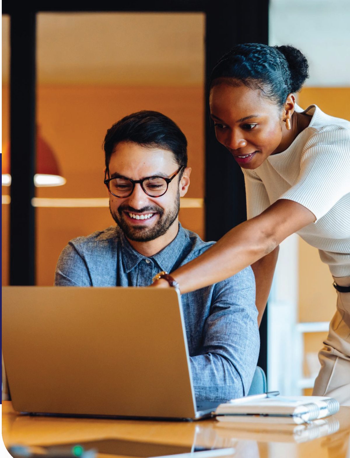 Two colleagues reviewing plan options together at a laptop